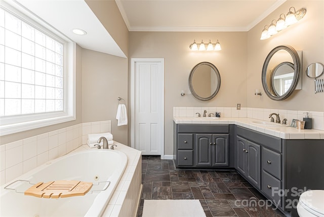 full bath with crown molding, a sink, a bath, and double vanity