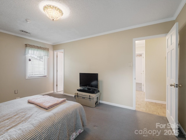 bedroom featuring baseboards, crown molding, visible vents, and a textured ceiling