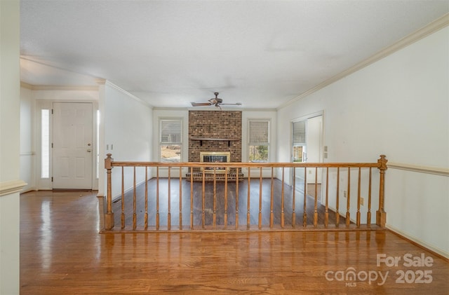 interior space with hardwood / wood-style floors and crown molding