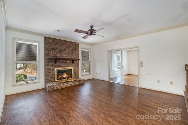 unfurnished living room with a brick fireplace, a textured ceiling, crown molding, dark wood-type flooring, and ceiling fan