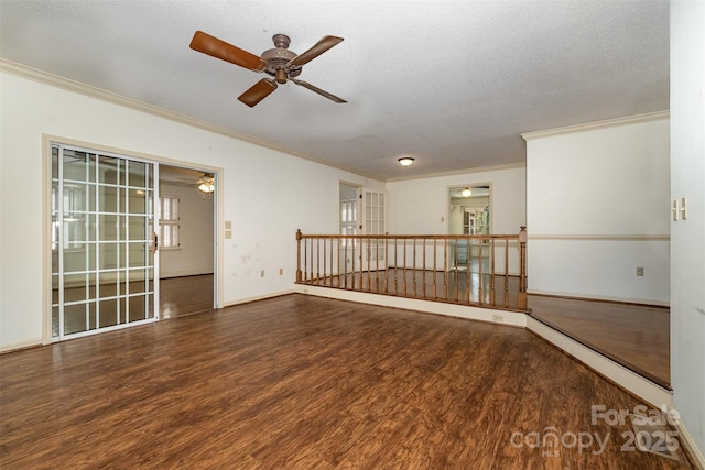 unfurnished room with ceiling fan, ornamental molding, dark wood-type flooring, and a textured ceiling