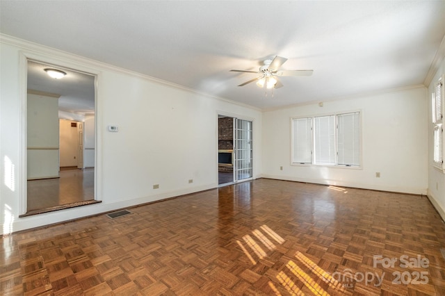 unfurnished room with crown molding, dark parquet flooring, and ceiling fan