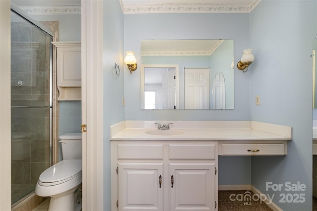 bathroom with vanity, toilet, and a shower with shower door