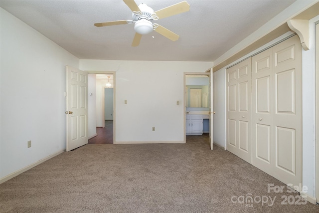 unfurnished bedroom with ceiling fan, a closet, and light colored carpet