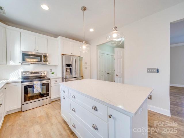 kitchen featuring light wood-type flooring, recessed lighting, appliances with stainless steel finishes, and a center island