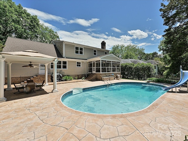 3600 Carmel Rd, Charlotte, NC 28226 - swimming pool featuring a water slide, a sunroom, a ceiling fan, and a patio