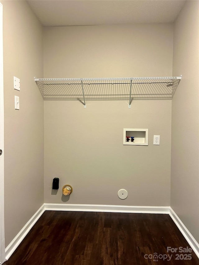 clothes washing area with laundry area, hookup for a washing machine, baseboards, and gas dryer hookup