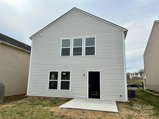 rear view of house with central air condition unit, a yard, and a patio area