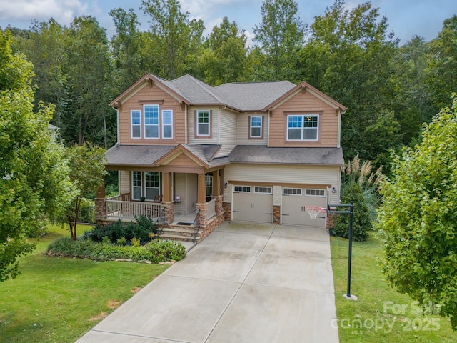 craftsman-style home with a garage, a front yard, and covered porch