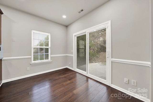 empty room featuring visible vents, recessed lighting, baseboards, and dark wood-style flooring