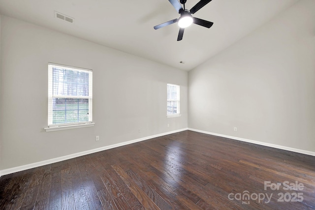 unfurnished room with lofted ceiling, hardwood / wood-style flooring, visible vents, and a wealth of natural light