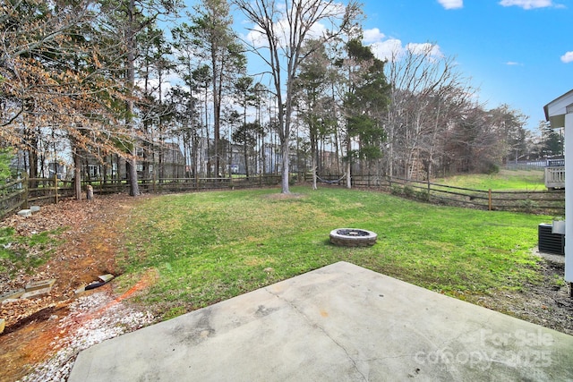 view of yard featuring a patio, a fenced backyard, and an outdoor fire pit