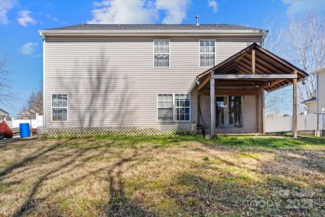 rear view of property with a yard
