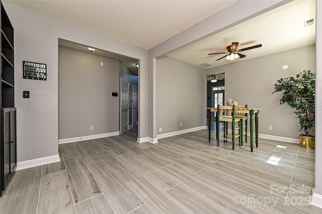 dining area with visible vents, ceiling fan, light wood-style flooring, and baseboards