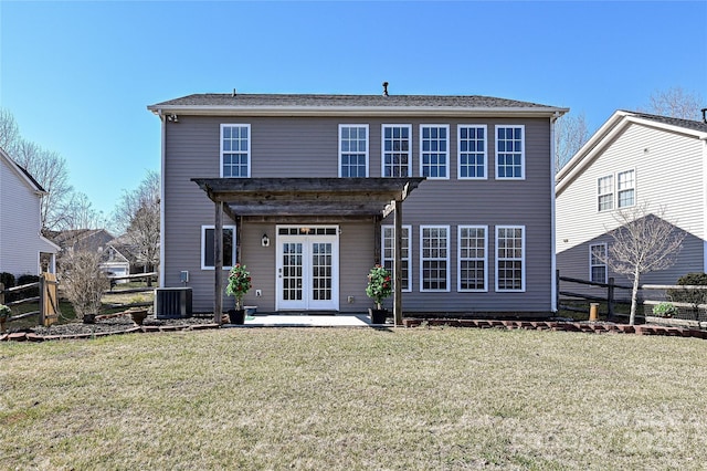 rear view of house featuring a lawn, fence, french doors, a patio area, and central AC