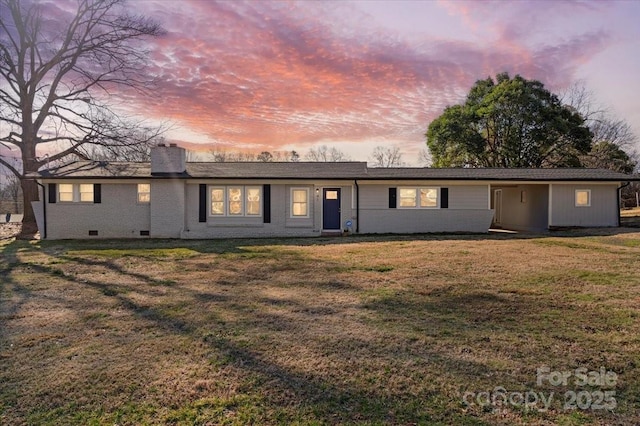 ranch-style home with a yard