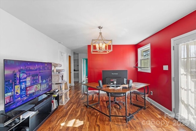 dining area with an inviting chandelier and hardwood / wood-style floors