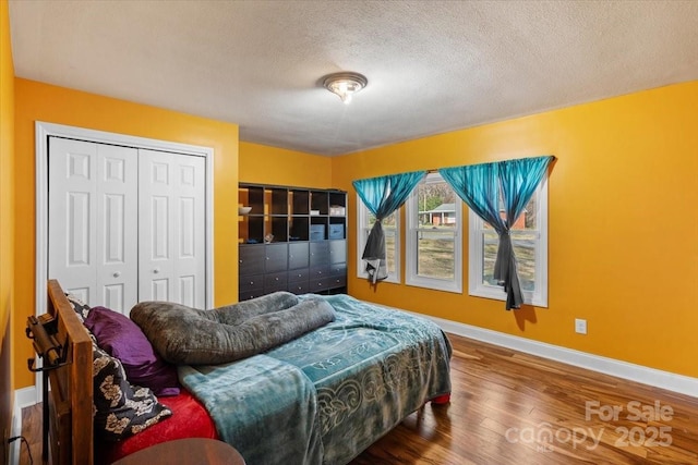 bedroom featuring hardwood / wood-style floors and a textured ceiling