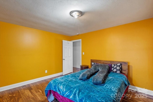 bedroom featuring hardwood / wood-style flooring and a textured ceiling