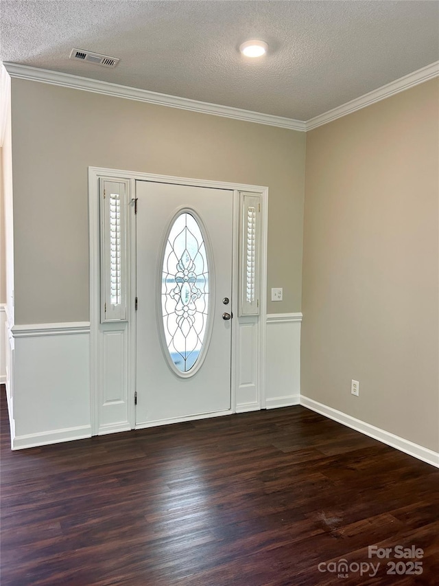 entryway featuring ornamental molding, dark wood-type flooring, and visible vents