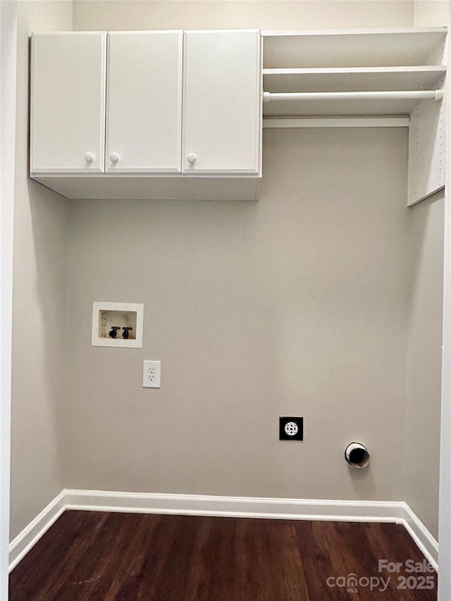 laundry area featuring hookup for an electric dryer, hookup for a washing machine, baseboards, dark wood finished floors, and cabinet space