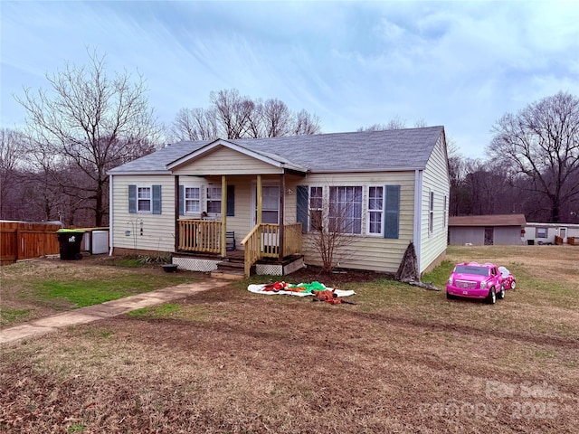 view of front of home featuring a front yard and covered porch