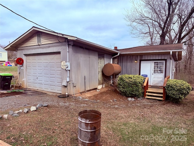 view of front of property featuring a garage and an outdoor structure