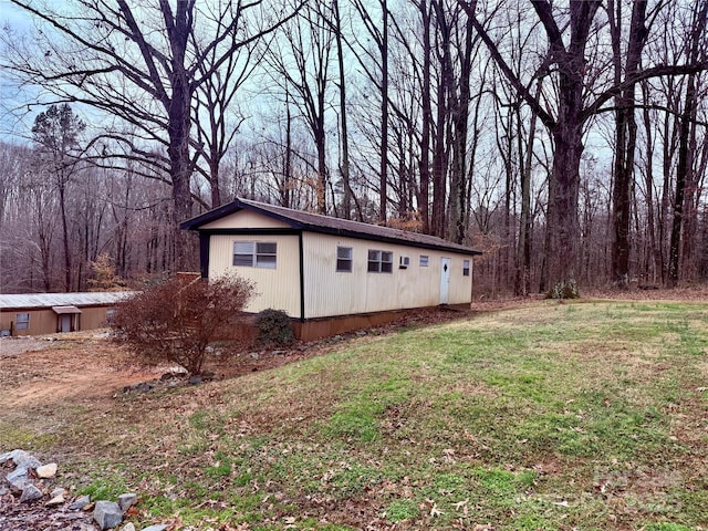 view of outbuilding featuring a lawn