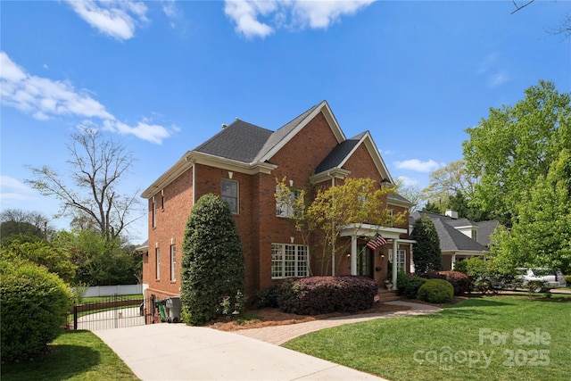 view of front facade featuring brick siding, a front lawn, and fence