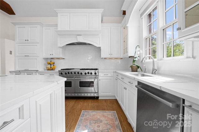 kitchen with dark wood-style floors, white cabinetry, appliances with stainless steel finishes, and a sink