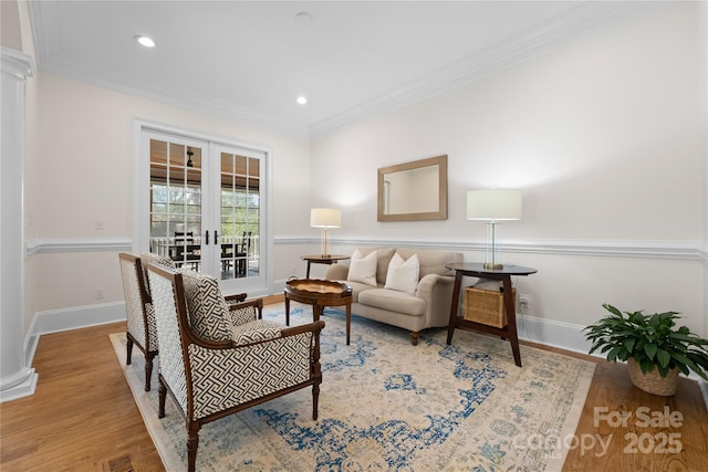 sitting room with recessed lighting, wood finished floors, baseboards, ornamental molding, and french doors