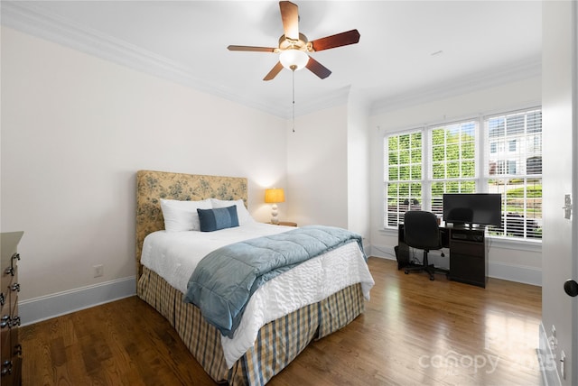 bedroom featuring ornamental molding, baseboards, and wood finished floors