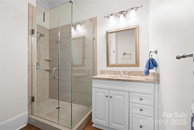 bathroom featuring a shower stall and vanity