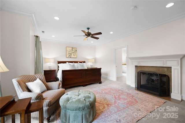 bedroom with a fireplace with flush hearth, ornamental molding, and recessed lighting