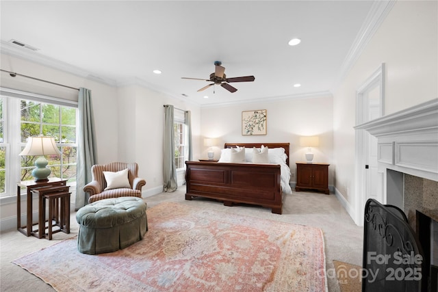 bedroom with ornamental molding, a fireplace, visible vents, and baseboards