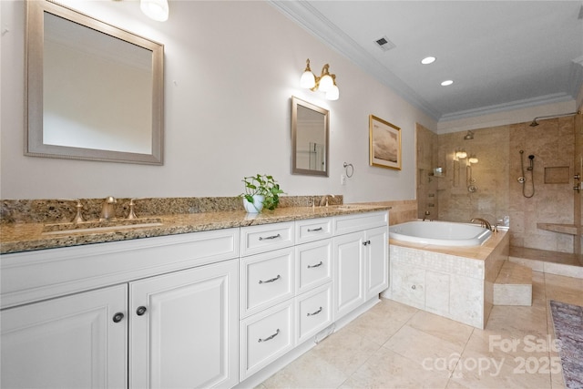 bathroom featuring crown molding, visible vents, a sink, and a bath