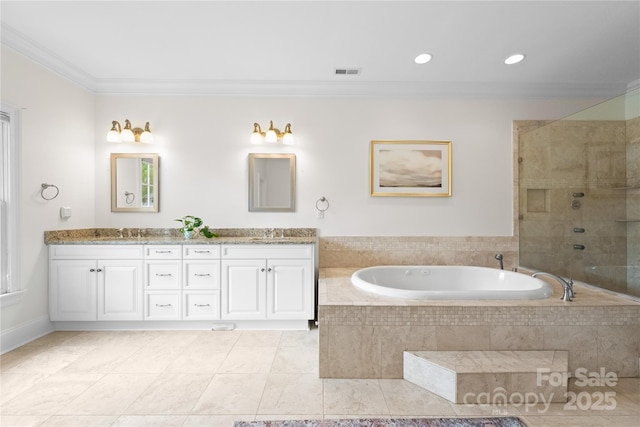 bathroom with double vanity, a garden tub, visible vents, and crown molding