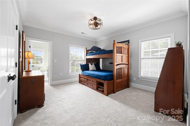 carpeted bedroom featuring baseboards, visible vents, and crown molding