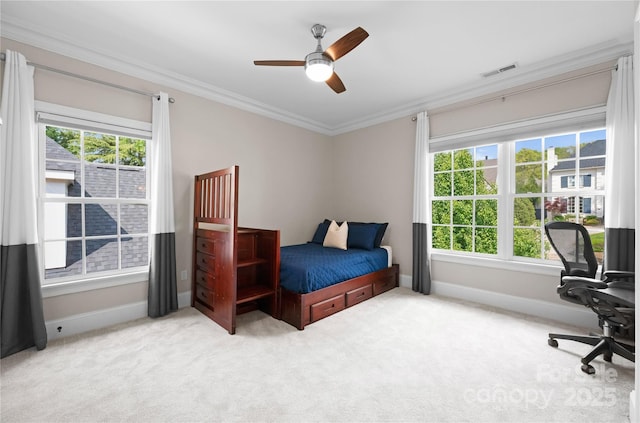 bedroom with carpet floors, ornamental molding, visible vents, and baseboards