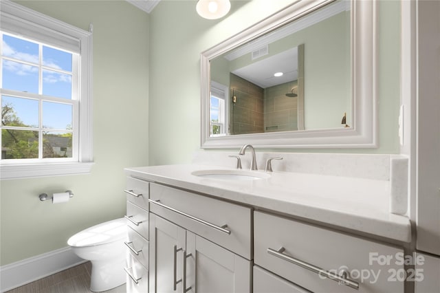 full bathroom with baseboards, visible vents, toilet, walk in shower, and vanity