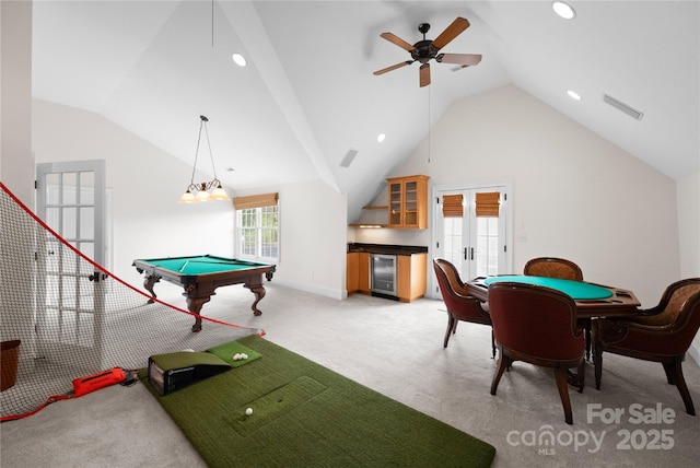 recreation room with wine cooler, french doors, light colored carpet, visible vents, and high vaulted ceiling