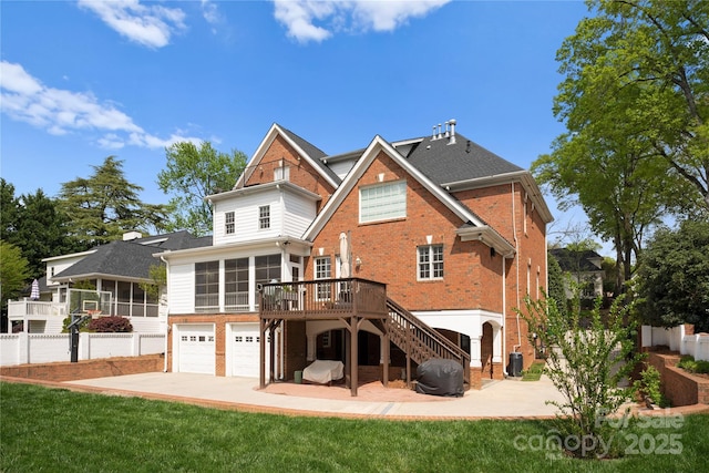 back of house featuring an attached garage, central AC, brick siding, a sunroom, and stairway