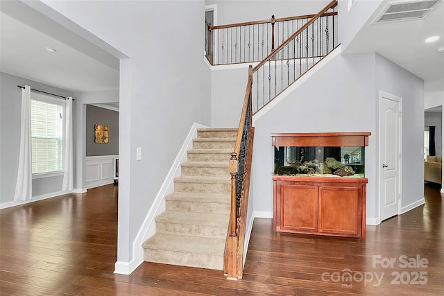 staircase with hardwood / wood-style flooring