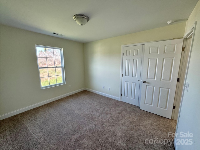 unfurnished bedroom featuring carpet floors and a closet