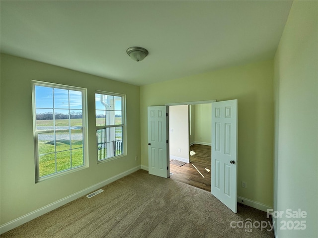 unfurnished bedroom featuring dark carpet