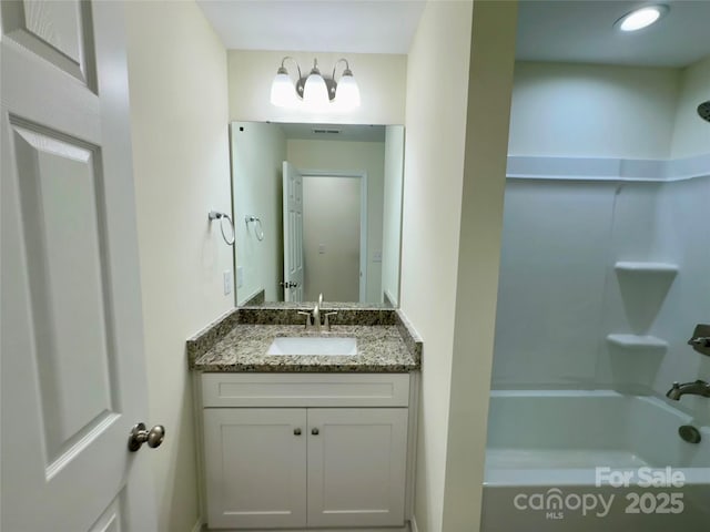 bathroom with vanity and bathing tub / shower combination