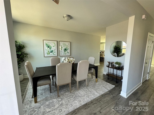 dining area featuring dark wood-type flooring