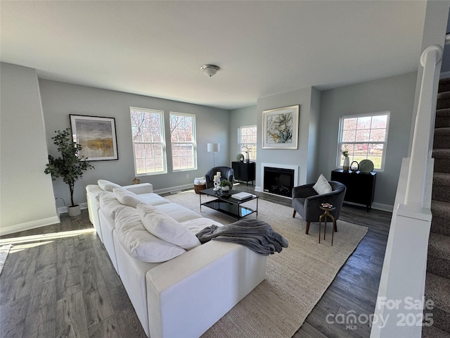 living room featuring plenty of natural light and dark wood-type flooring