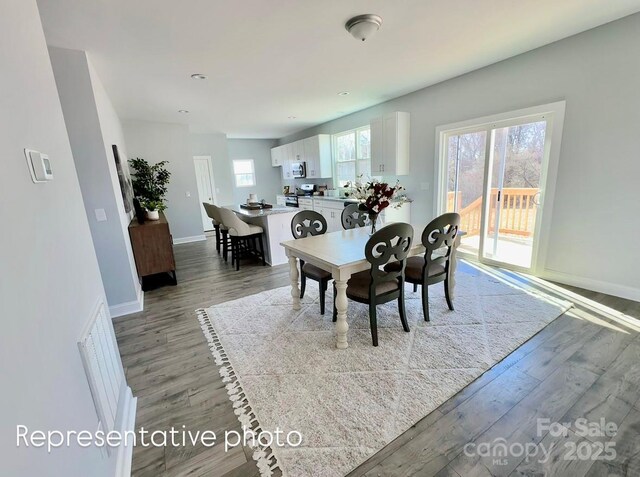 1022 Heath Helms Rd, Monroe, NC 28110 - dining room with wood finished floors and baseboards