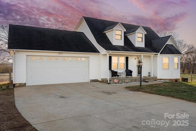 new england style home with a garage and covered porch